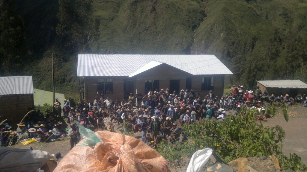 Survivor crowd gathering at schoolhouse