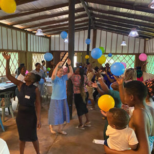 Ingrid and others in classroom keep balloons up in the air