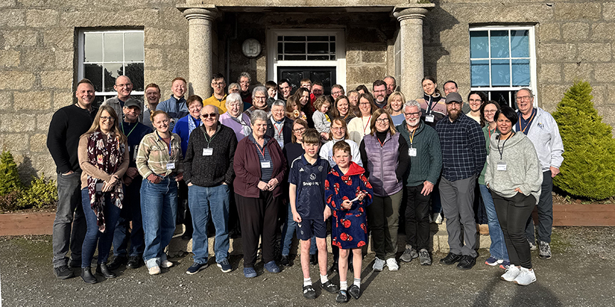 group of BCM missionaries standing in front of historic building in Northern Ireland